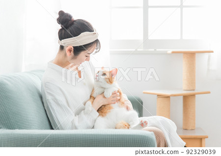 Japanese woman holding a cat at home (pet, owner, cat tower) Japanese woman holding a cat at home (pet, owner, cat tower) 92329039