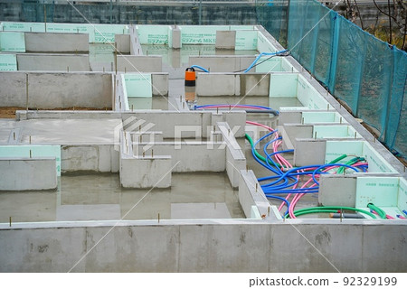 Water collects in the foundation of a new house and is being pumped up by a submersible pump Water collects in the foundation of a new house and is being pumped up by a submersible pump 92329199