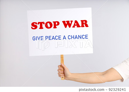 Female hand holds protest sign with text Female hand holds protest sign with text 92329241