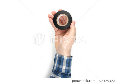 Male hand holds insulating tape, isolated on white background 92329328