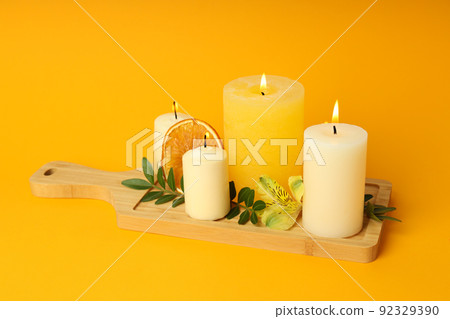 Concept of relaxation with aroma candles on orange background 92329390