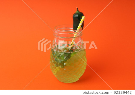 Concept of drink with Jalapeno cocktail on orange background Concept of drink with Jalapeno cocktail on orange background 92329442