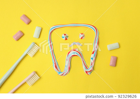 Concept of tooth or oral care on yellow background 92329626