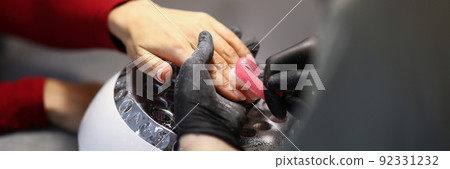 Nail master cleaning clients hands from dust with special brush 92331232