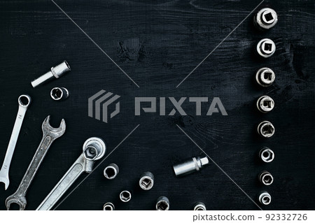 Tools for car repair in Workshop. Car repair equipment on black wooden background in car repair shop Tools for car repair in Workshop. Car repair equipment on black wooden background in car repair shop 92332726