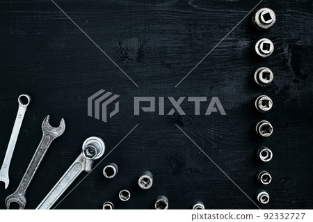 Tools for car repair in Workshop. Car repair equipment on black wooden background in car repair shop Tools for car repair in Workshop. Car repair equipment on black wooden background in car repair shop 92332727