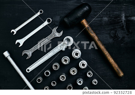 Flat lay of set of tools for car repairing such as wrenches on black wooden background. Top view. Flat lay of set of tools for car repairing such as wrenches on black wooden background. Top view. 92332728