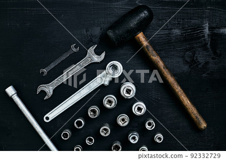 Flat lay of set of tools for car repairing such as wrenches on black wooden background. Top view. Flat lay of set of tools for car repairing such as wrenches on black wooden background. Top view. 92332729