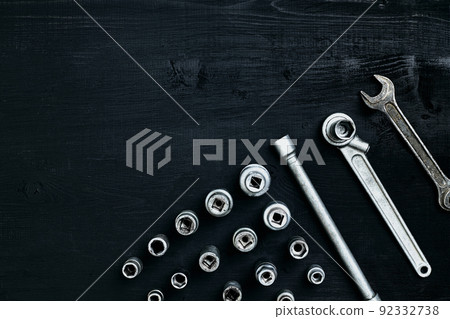 Tools for car repair in Workshop. Car repair equipment on black wooden background in car repair shop Tools for car repair in Workshop. Car repair equipment on black wooden background in car repair shop 92332738