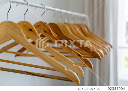 Close-up of wardrobe with wooden clothes hanger, Close-up of wardrobe with wooden clothes hanger, 92333004