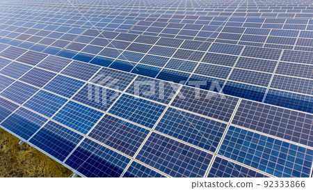 Aerial drone view flight over solar power station panels. Aerial top view of solar farm. Green energy, electrical innovation. Renewable Energy. Industrial Solar Energy Farm producing solar power. Aerial drone view flight over solar power station panels. Aerial top view of solar farm. Green energy, electrical innovation. Renewable Energy. Industrial Solar Energy Farm producing solar power. 92333866