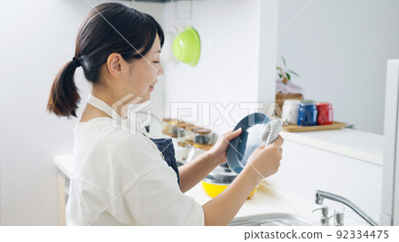 Woman wiping dishes in the kitchen (housework / housewife) Woman wiping dishes in the kitchen (housework / housewife) 92334475