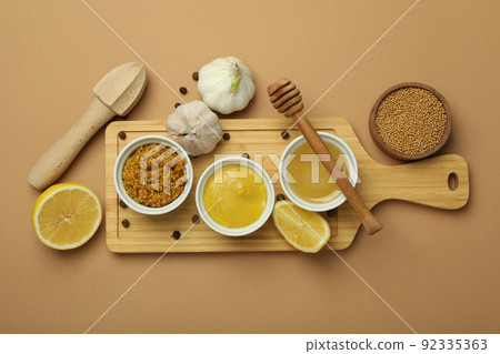 Concept of cooking honey mustard sauce, top view Concept of cooking honey mustard sauce, top view 92335363