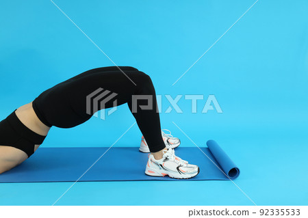Concept of healthy lifestyle with sporty woman on blue background 92335533