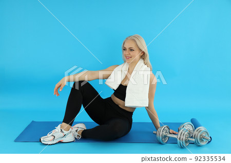 Concept of healthy lifestyle with sporty woman on blue background 92335534