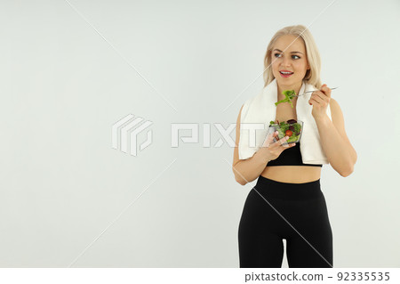 Concept of healthy lifestyle with sporty woman on light background 92335535