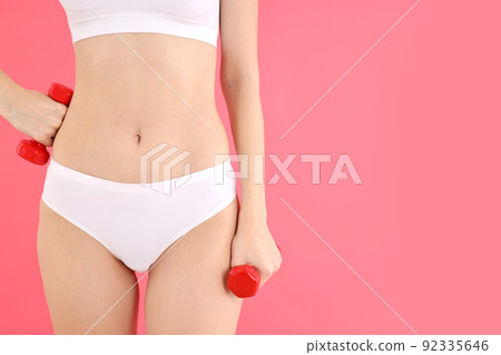 Concept of weight loss with young slim woman on pink background Concept of weight loss with young slim woman on pink background 92335646