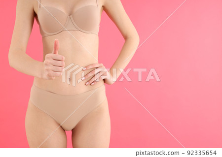 Concept of weight loss with young slim woman on pink background 92335654