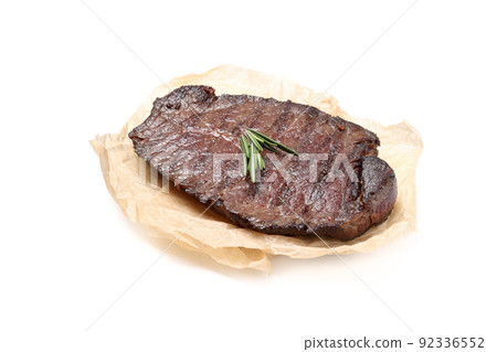 Baking paper with beef steak isolated on white background 92336552