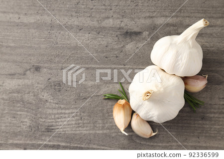 Garlic with rosemary on gray textured background Garlic with rosemary on gray textured background 92336599