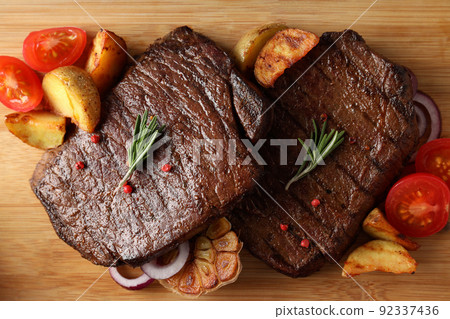 Concept of tasty food with beef steaks, close up 92337436