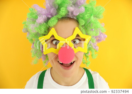 Concept of April Fool's Day on yellow background Concept of April Fool's Day on yellow background 92337494