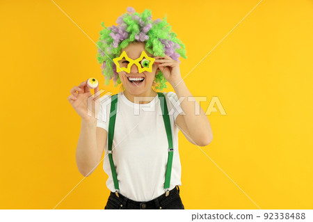 Concept of April Fool's Day on yellow background Concept of April Fool's Day on yellow background 92338488