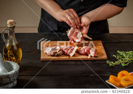 Preparing quail specialty, rolling quail with bacon 92340828