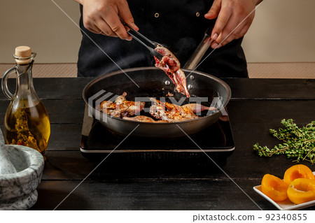 Chef cook the quail into the frying pan 92340855