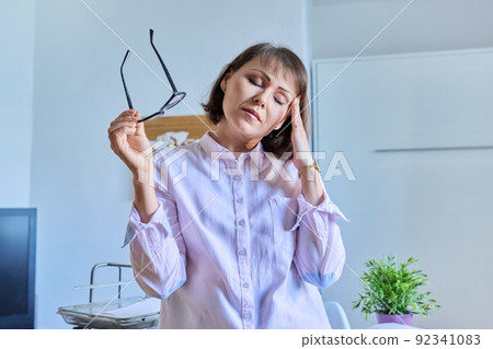 Mature tired woman experiencing stress headache depression Mature tired woman experiencing stress headache depression 92341083