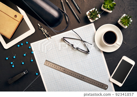 Top view of the builder's workplace, ruler, paper for drawings, compasses, glasses, tablet 92341857