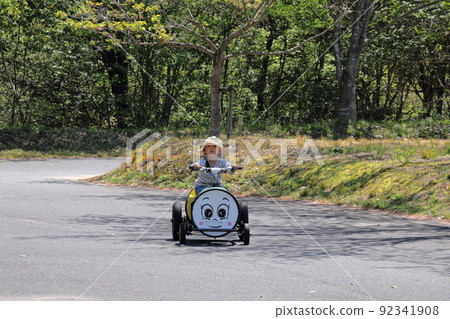A child riding a strange bicycle A child riding a strange bicycle 92341908