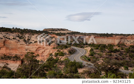 Scenic Road surrounded by Red Rock Mountains in the Desert. 92343125