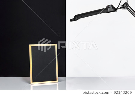 Blank blackboard on table near white and black wall. Blank blackboard on table near white and black wall. 92343209
