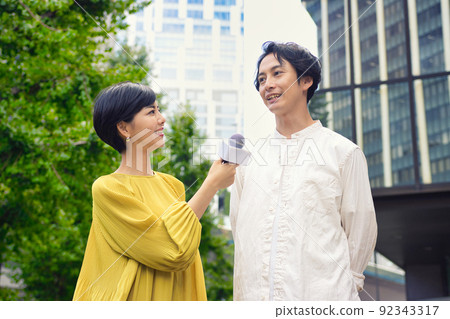 A man receiving a street interview 92343317