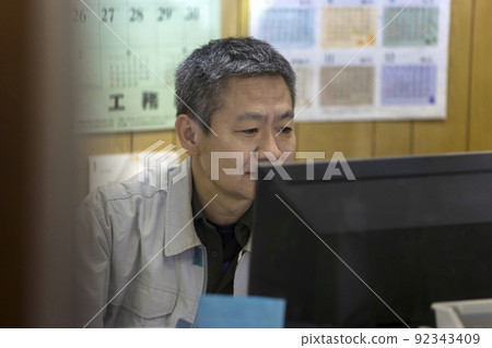 Middle man doing desk work in the office of the company Middle man doing desk work in the office of the company 92343409