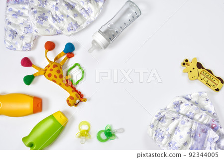 Set of accessories for baby. Pacifier, bottle, diaper, cream on white background. Set of accessories for baby. Pacifier, bottle, diaper, cream on white background. 92344005
