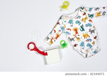 Baby care accessories and clothing on white background, top view Baby care accessories and clothing on white background, top view 92344071
