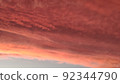 Abstract dark red background. Dramatic red sky. Red sunset with clouds. Fantastic sunset background with copy space for design. Halloween, armageddon, apocalypse, end of the world concept. 92344790