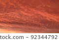 Abstract dark red background. Dramatic red sky. Red sunset with clouds. Fantastic sunset background with copy space for design. Halloween, armageddon, apocalypse, end of the world concept. 92344792