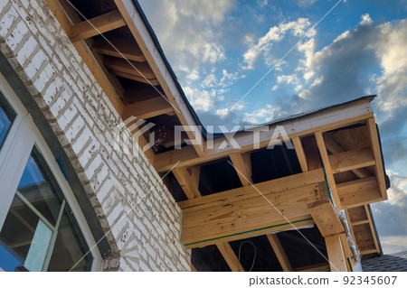 Soffit installation in a new home after preparation for soffit installation on the roof 92345607