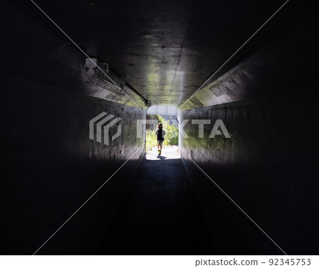 A child on the other side of a small tunnel A child on the other side of a small tunnel 92345753