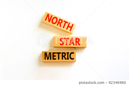 North star metric symbol. Concept words North star metric on wooden blocks on a beautiful white table white background. Business finacial and north star metric concept. Copy space. 92346960