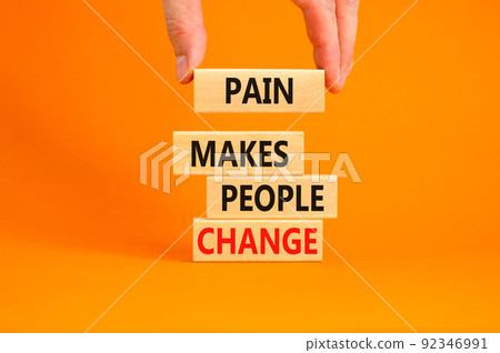 Pain makes people change symbol. Concept words Pain makes people change on wooden blocks on a beautiful orange table orange background. Business, motivational and pain makes people change concept. 92346991