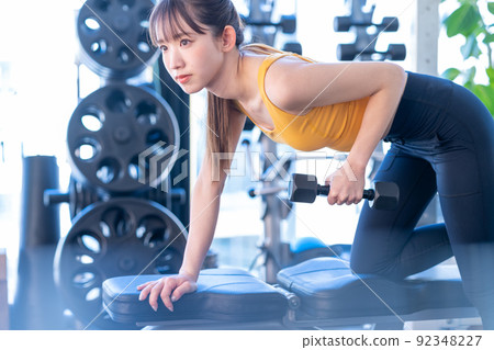 Young woman training in a sports gym Young woman training in a sports gym 92348227