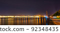 Night panorama of the Neva River and St. Petersburg, Russia. View of the Fregat Blagodat and the Trinity Bridge 92348435