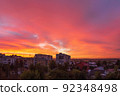 Bright coral sky before dawn in a provincial residential area of the city with high-rise buildings. Cityscape. 92348498