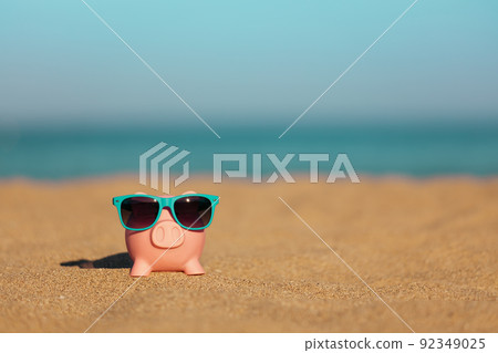 Piggybank on the beach in summer 92349025