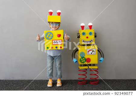 Happy child with robot have an idea 92349077