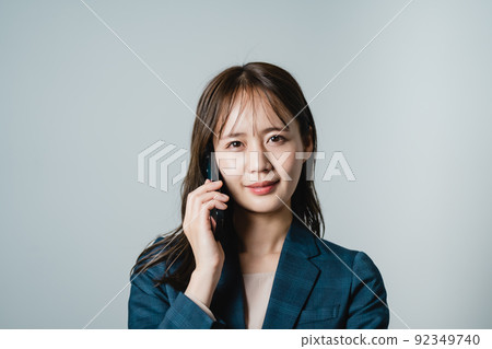 Business person woman making a phone call Business person woman making a phone call 92349740